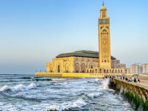 Blick auf die Hassan-II.-Moschee und den Ozean in Casablanca bei Sonnenuntergang.