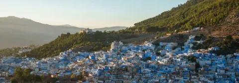 Blick über die Stadt Chefchaouen mit ihren berühmte bauen Häusern, gelegen am grünen Berghang