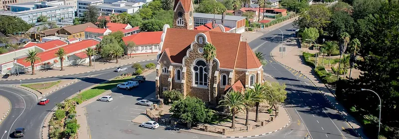 Eine Luftaufnahme der Kirche von Windhoek auf einem Kreisverkehr an einem hellen Sonnentag.
