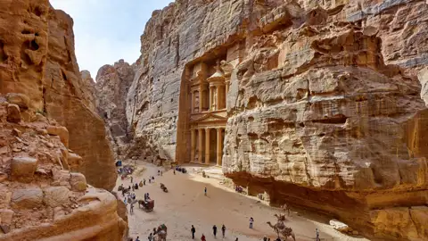 Kaum ein Sonnenstrahl dringt zu uns, wenn wir zwischen Felswänden durch den schmalen Sik gehen. Diese Schlucht ist der Zugang zur Nabatäerstadt Petra. Nach zwei Kilometern zwischen engen Canyonwänden taucht das gigantische Schatzhaus des Pharao vor uns auf. Das erwartet Sie auf unserer Rundreise durch Jordanien.